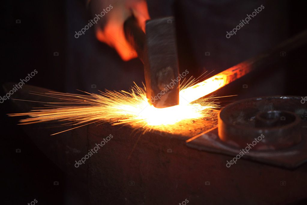 Schmied arbeitet an glühendem Metall in einer Werkstatt